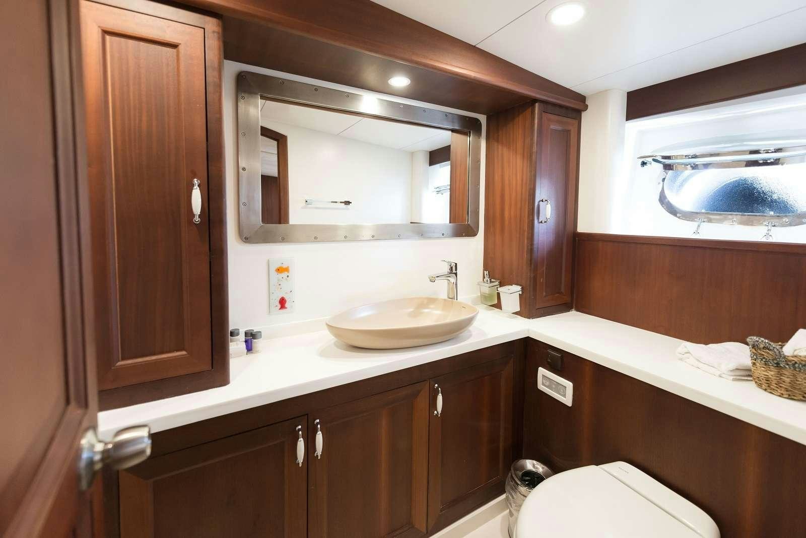 a bathroom with a sink and a mirror aboard VIRTUOSO Yacht for Charter