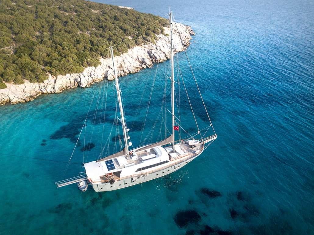 a boat sailing on the water aboard VIRTUOSO Yacht for Charter