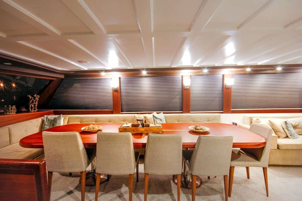 a room with tables and chairs aboard VIRTUOSO Yacht for Charter