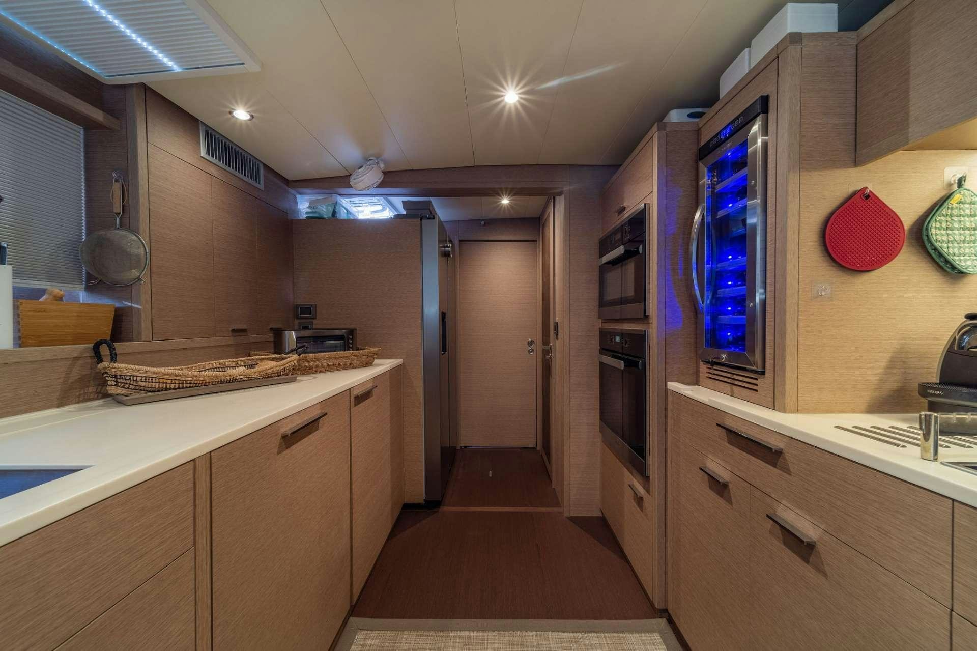 a kitchen with a large refrigerator aboard JUST MARIE Yacht for Charter