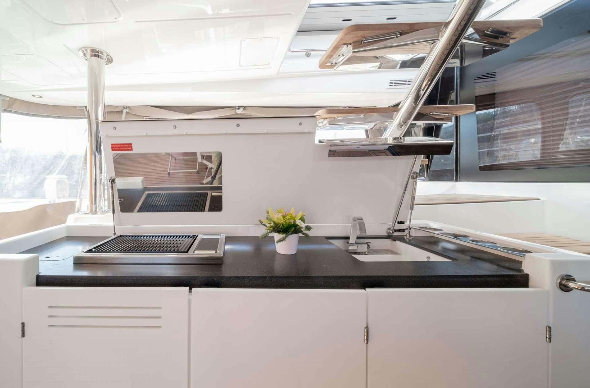 a kitchen with a sink and a microwave aboard JUST MARIE Yacht for Charter