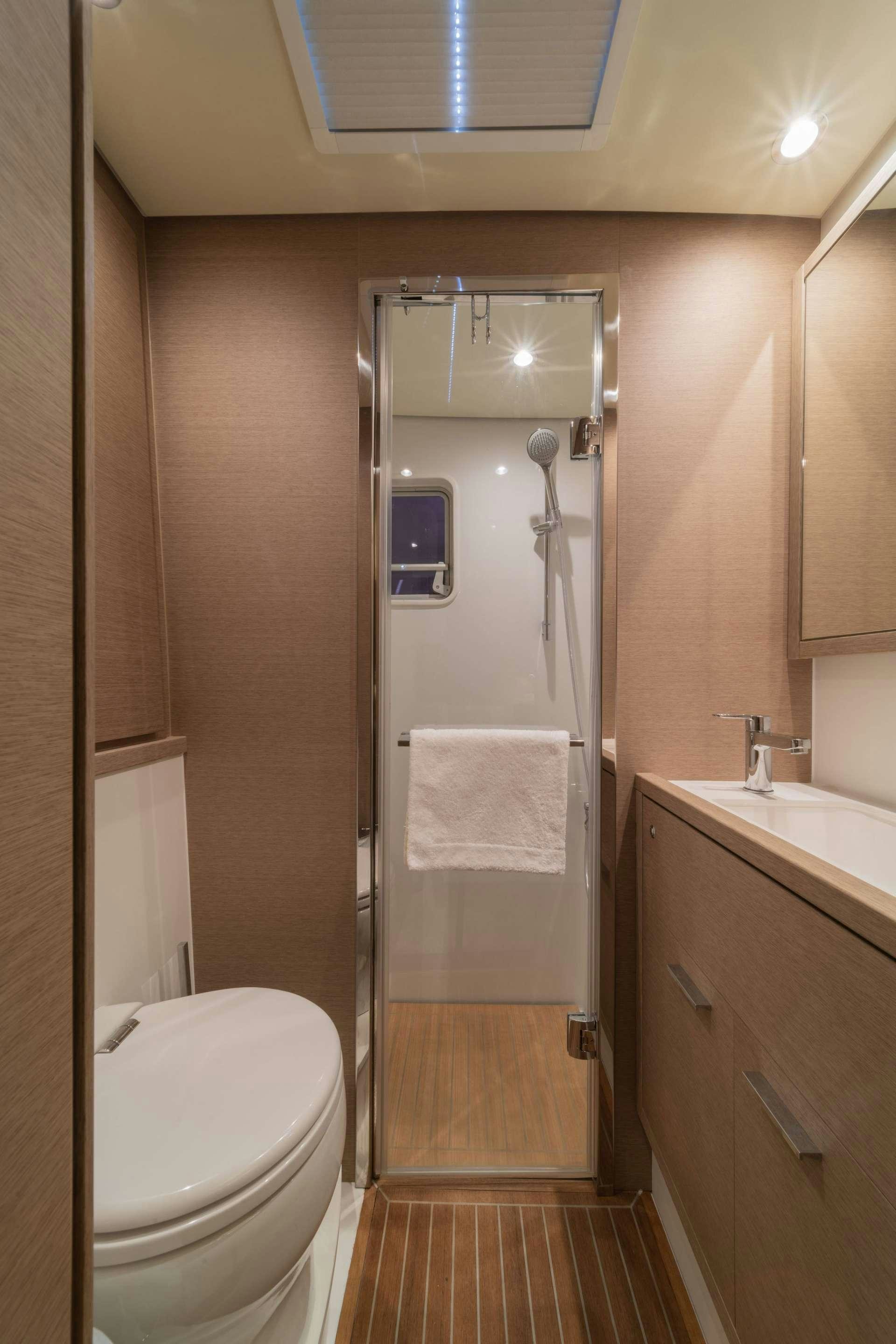 a bathroom with a shower unit and sink aboard JUST MARIE Yacht for Charter