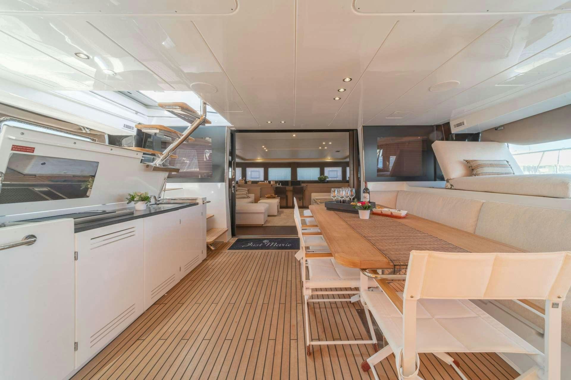 a kitchen with a table and chairs aboard JUST MARIE Yacht for Charter