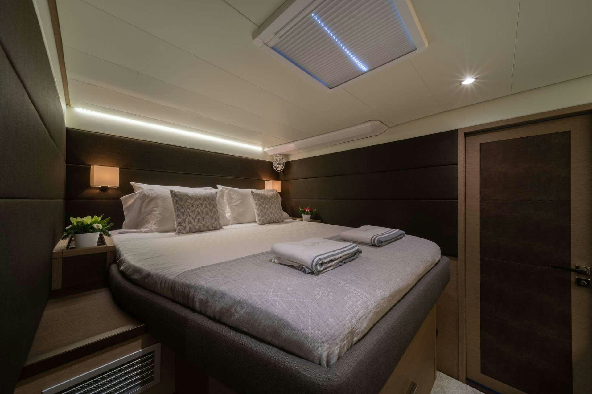 a bed with a white sheet aboard JUST MARIE Yacht for Charter