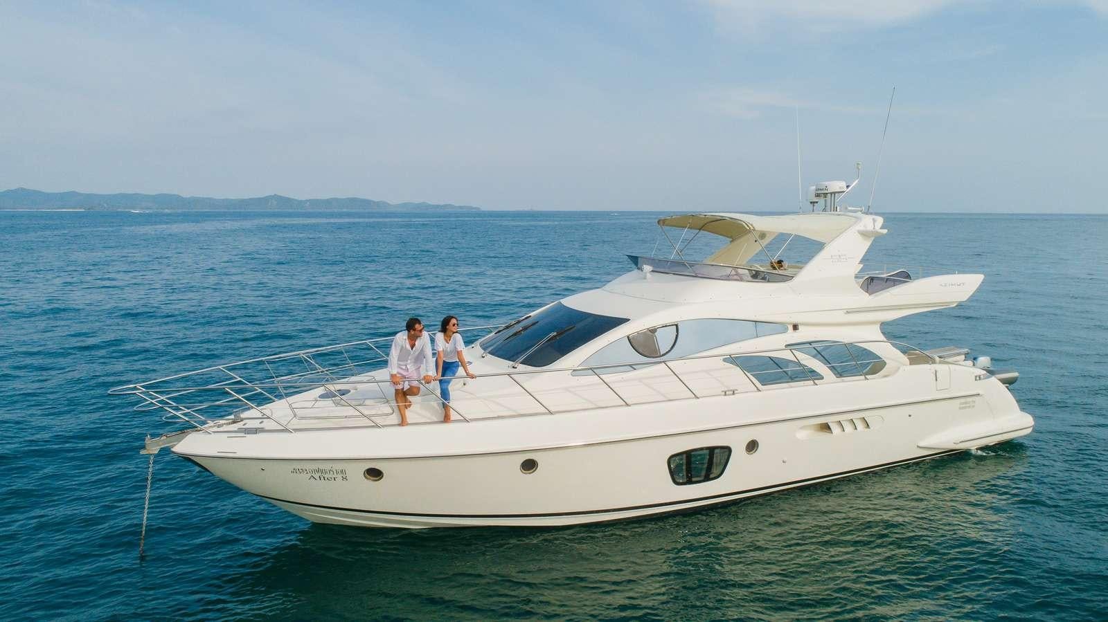 two people standing on a boat aboard AFTER 8 Yacht for Charter