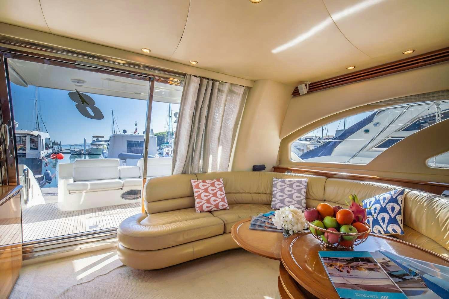 a living room with a couch and a table with fruits on it aboard AFTER 8 Yacht for Charter