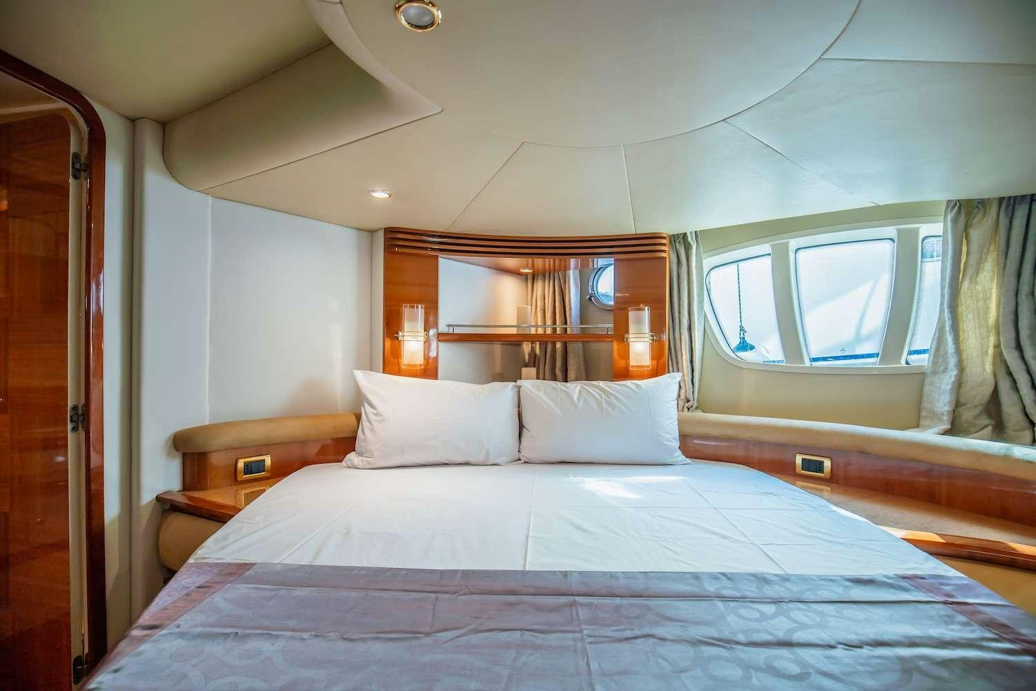 a bed with white sheets aboard AFTER 8 Yacht for Charter