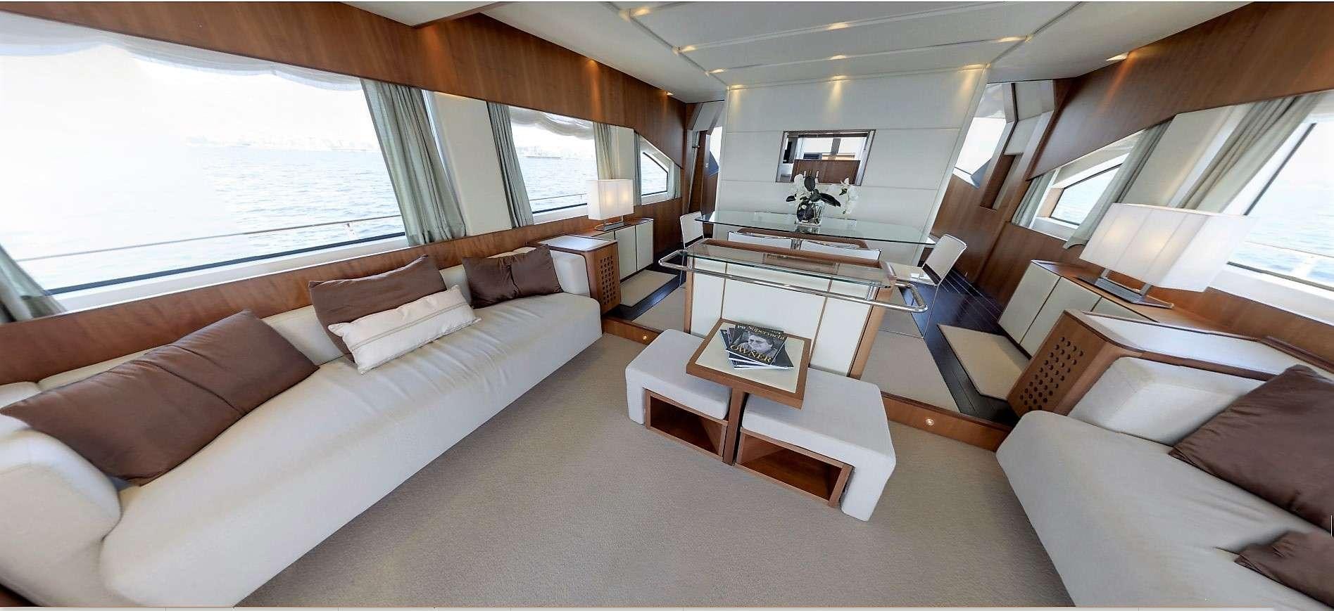 a living room with a large sofa aboard QUESTA E VITA Yacht for Charter