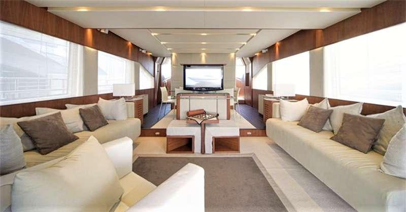 a living room with a couch and a tv aboard QUESTA E VITA Yacht for Charter