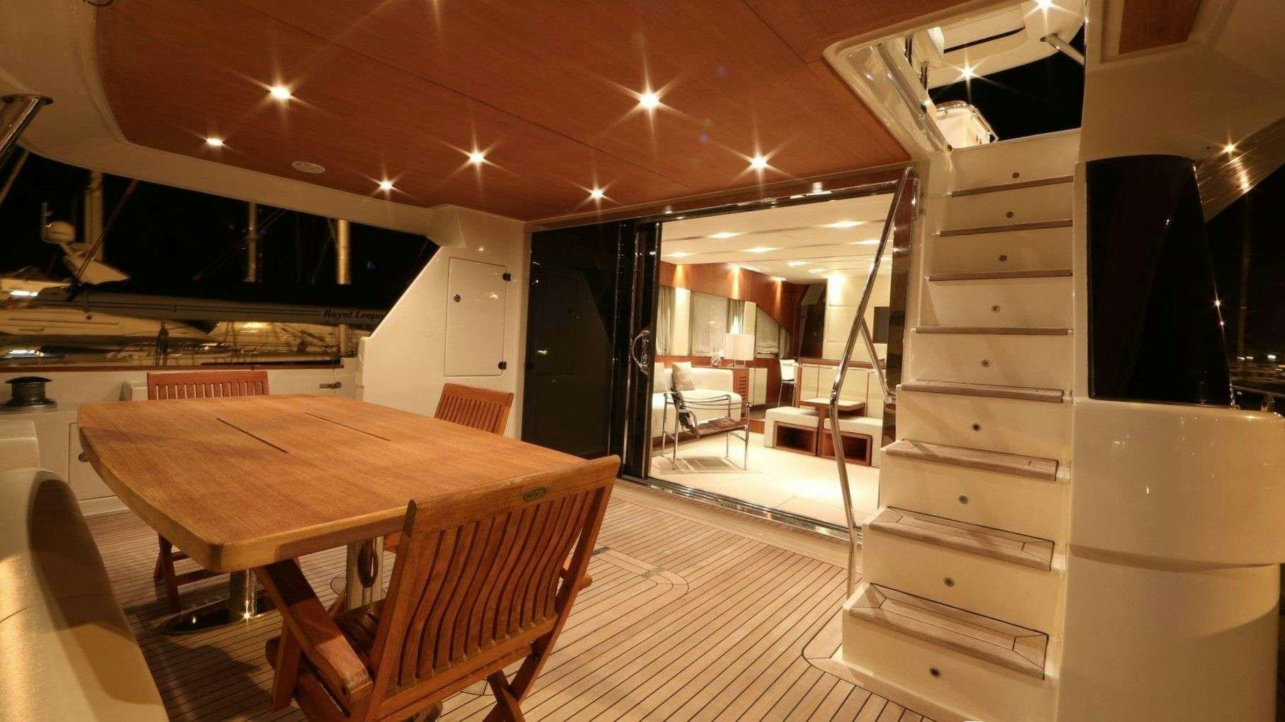 a room with a table and chairs aboard QUESTA E VITA Yacht for Charter