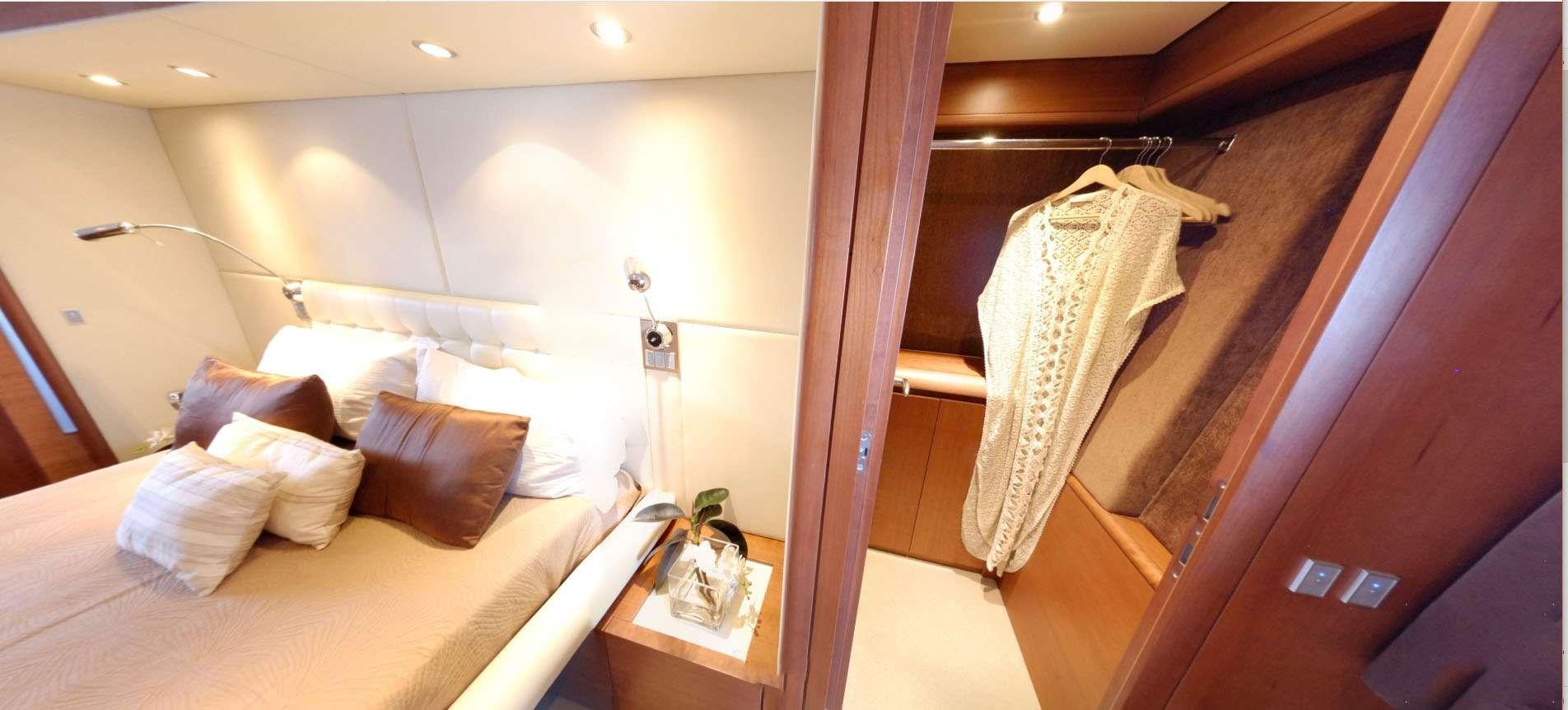 a bed with a white sheet and pillows aboard QUESTA E VITA Yacht for Charter