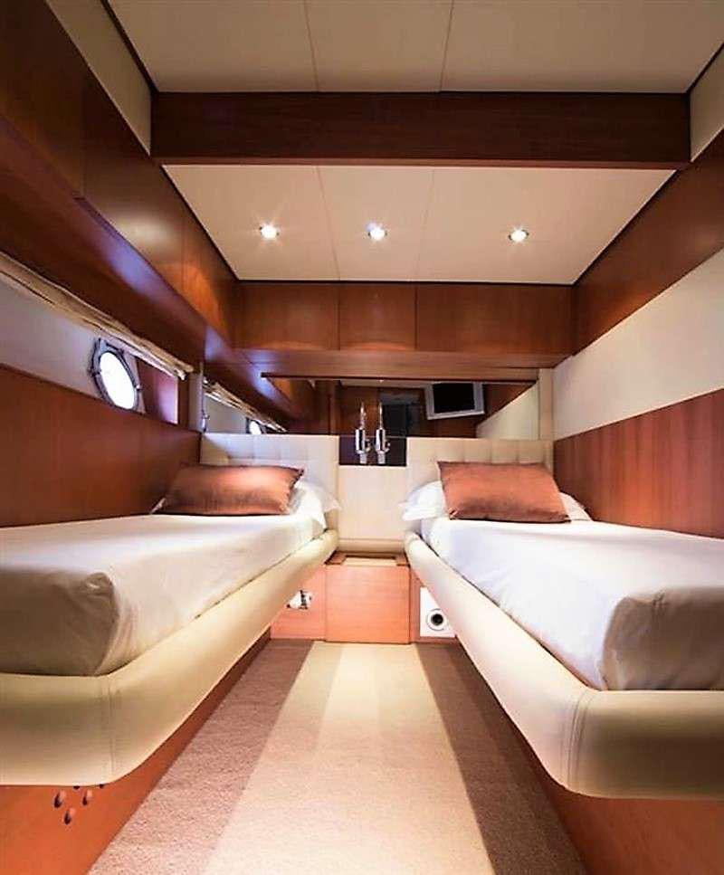 a room with a bed and a couch aboard QUESTA E VITA Yacht for Charter