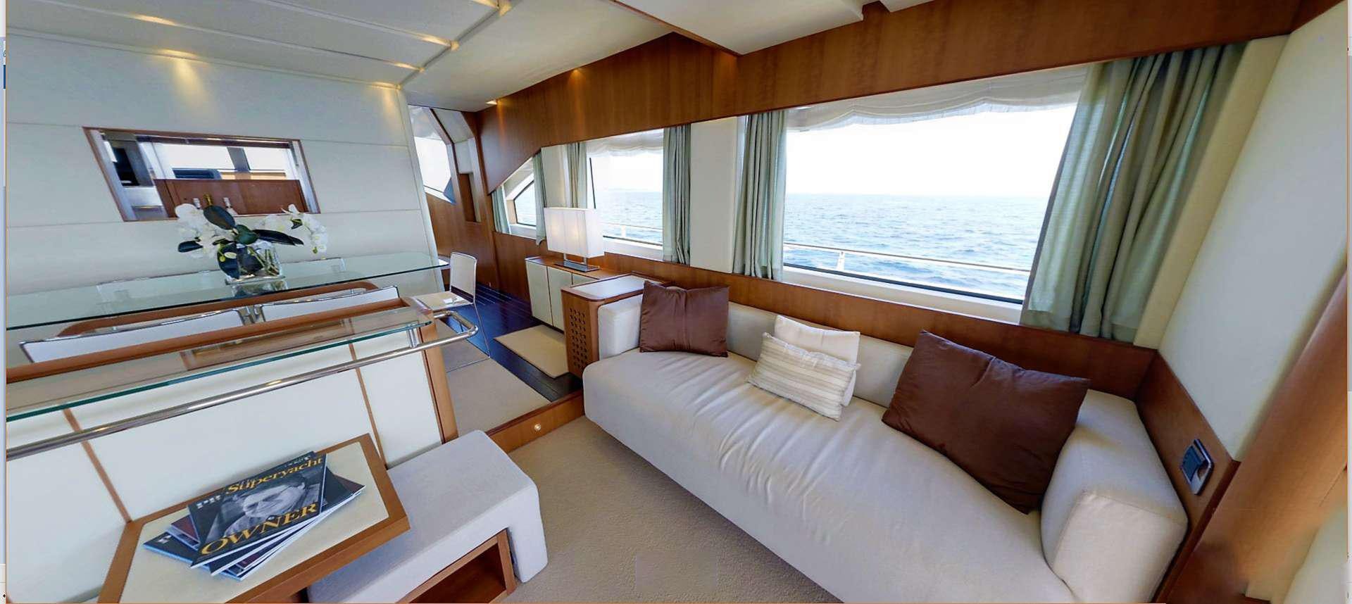 a room with a couch and a table aboard QUESTA E VITA Yacht for Charter