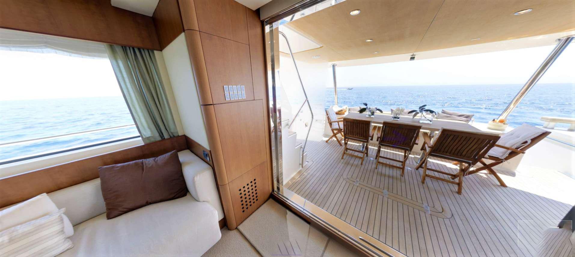 a room with a bed and a table and chairs aboard QUESTA E VITA Yacht for Charter