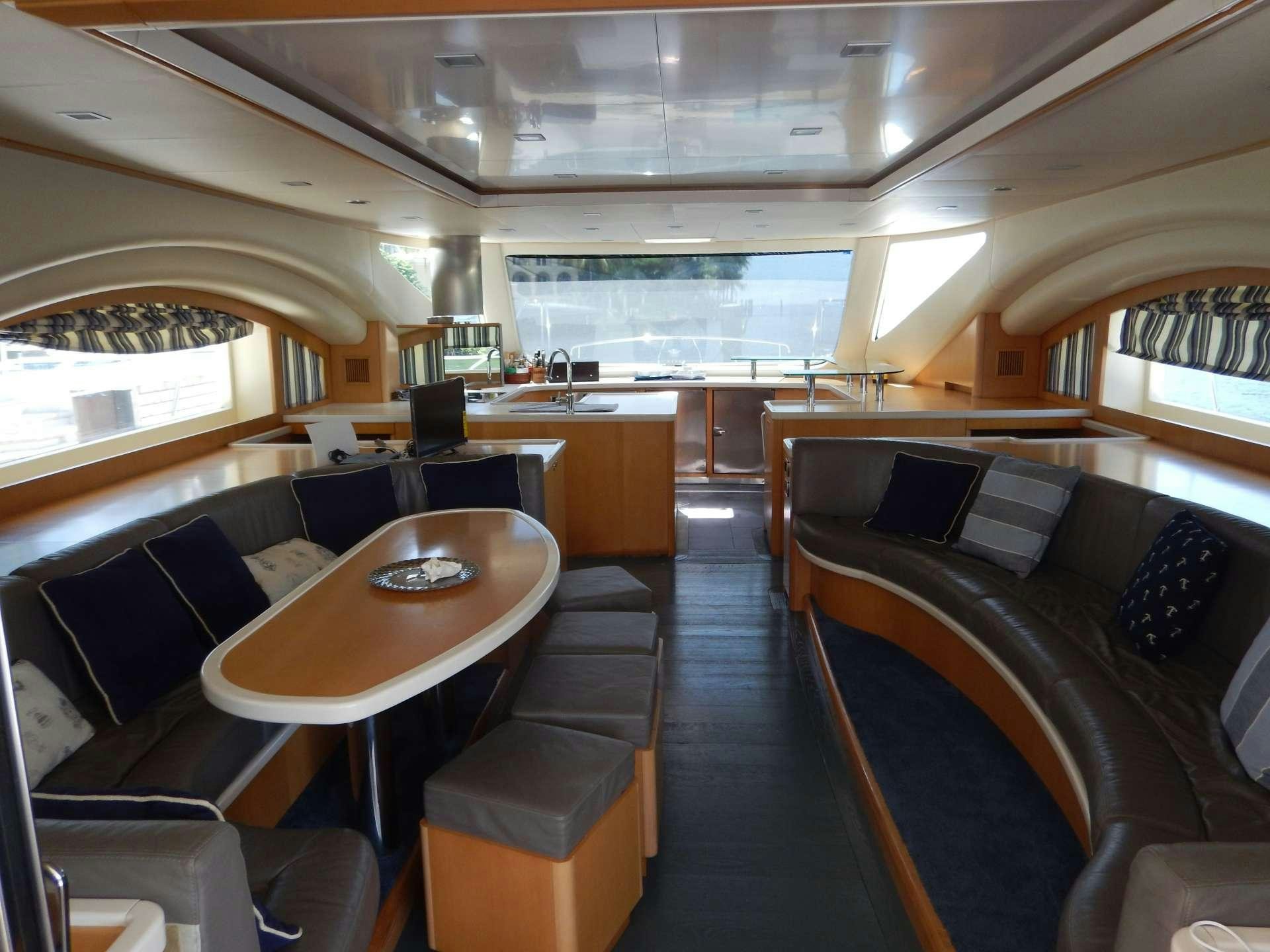 a room with a table and chairs aboard MAGIC STAR Yacht for Charter