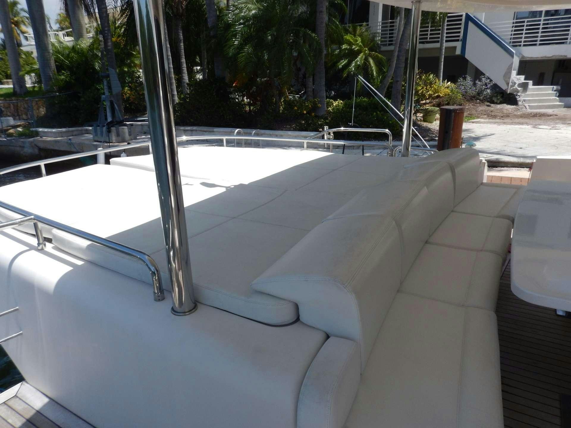 a white couch on a patio aboard MAGIC STAR Yacht for Charter