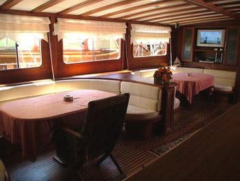 a room with a table and chairs aboard KAPTAN YILMAZ Yacht for Charter