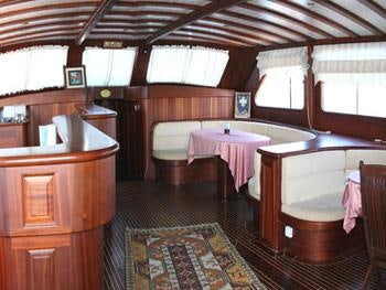 a room with a bed and a chair aboard KAPTAN YILMAZ Yacht for Charter