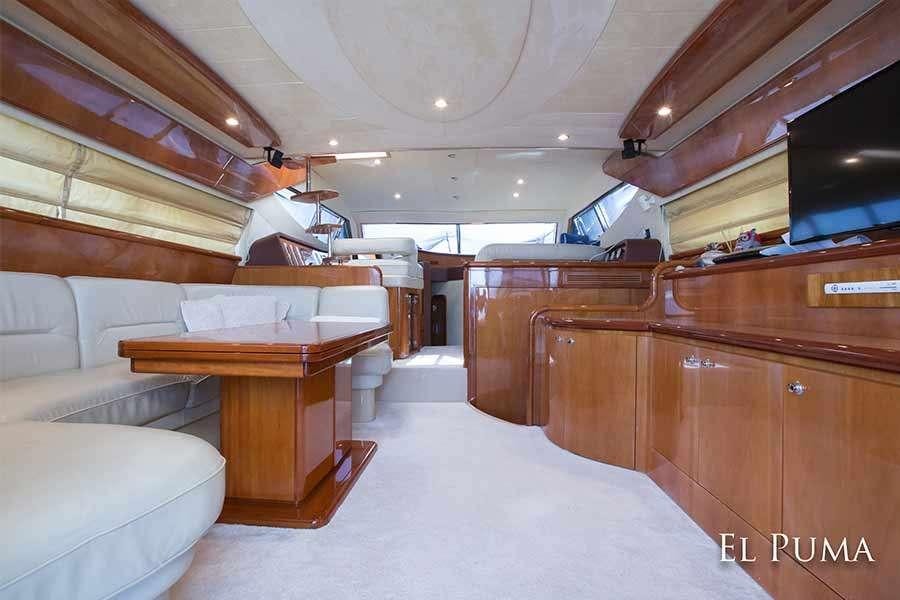 a room with wooden furniture aboard EL PUMA Yacht for Charter