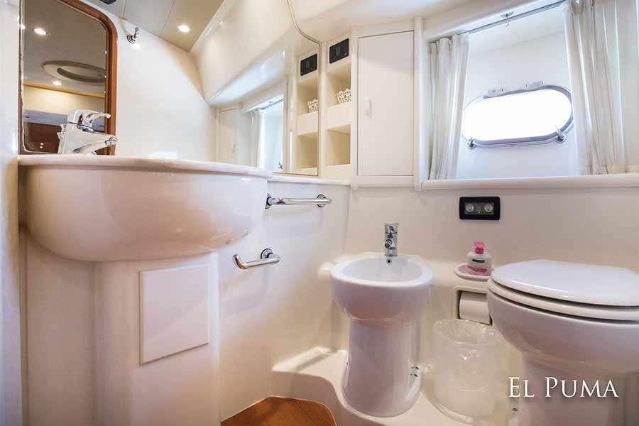 a bathroom with a sink and toilet aboard EL PUMA Yacht for Charter