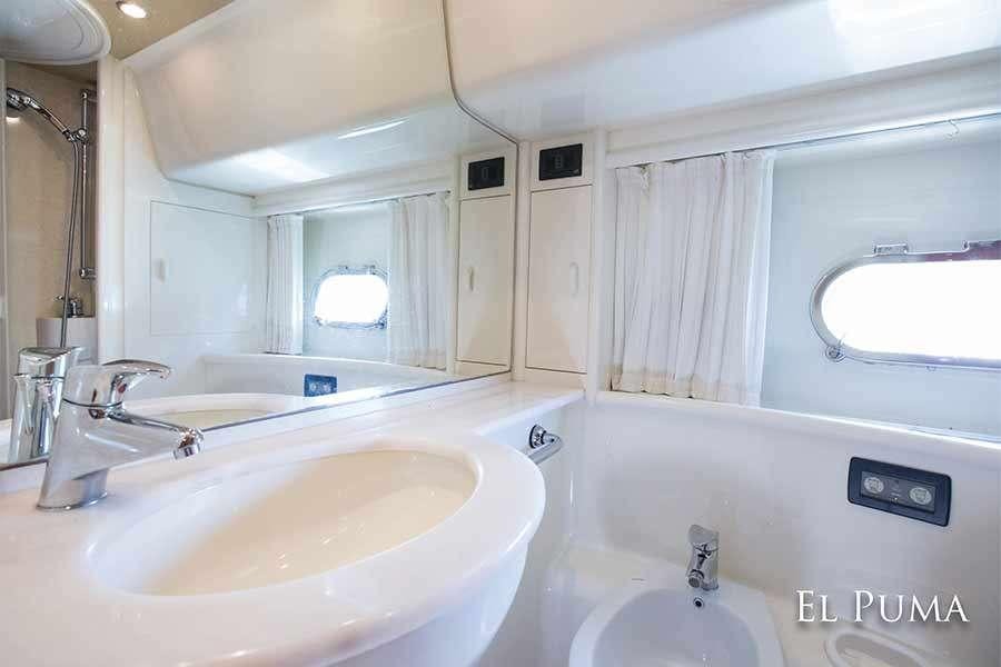 a bathroom with a sink and a bathtub aboard EL PUMA Yacht for Charter