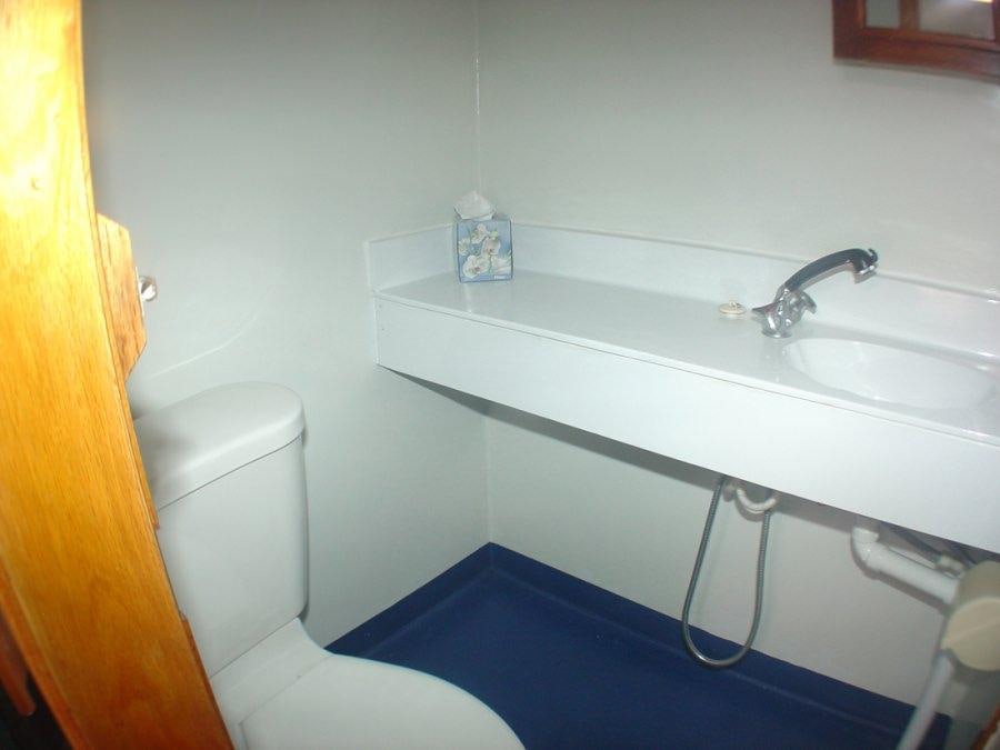 a bathroom with a sink and a toilet aboard CUAN LAW Yacht for Charter