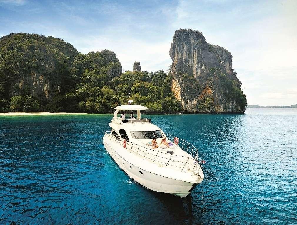 a boat in the water with Phi Phi Islands in the background aboard LADY KATHRYN Yacht for Charter