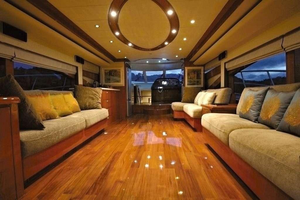 a living room with a wood floor aboard LADY KATHRYN Yacht for Charter