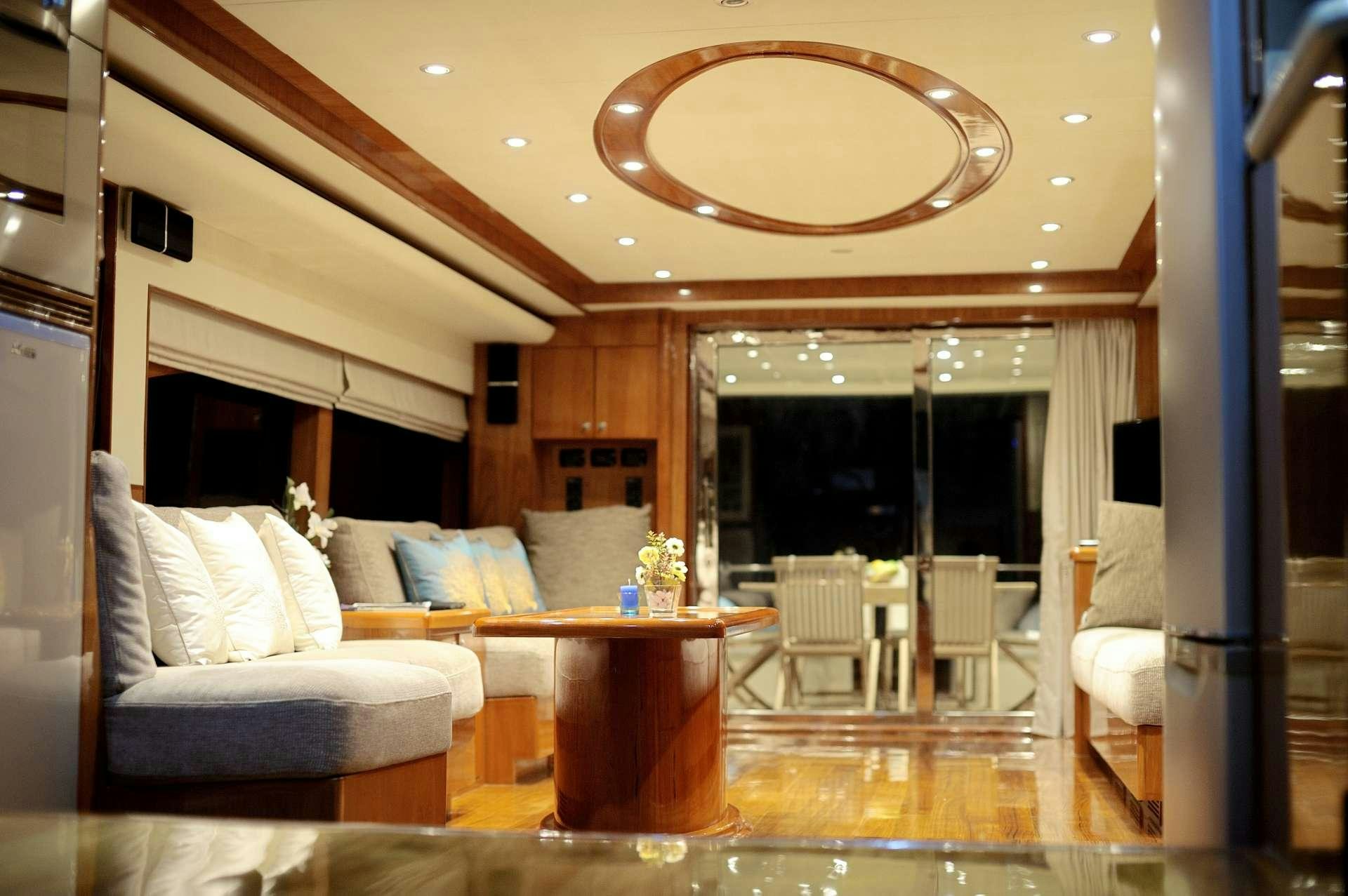 a living room with a large chandelier aboard LADY KATHRYN Yacht for Charter