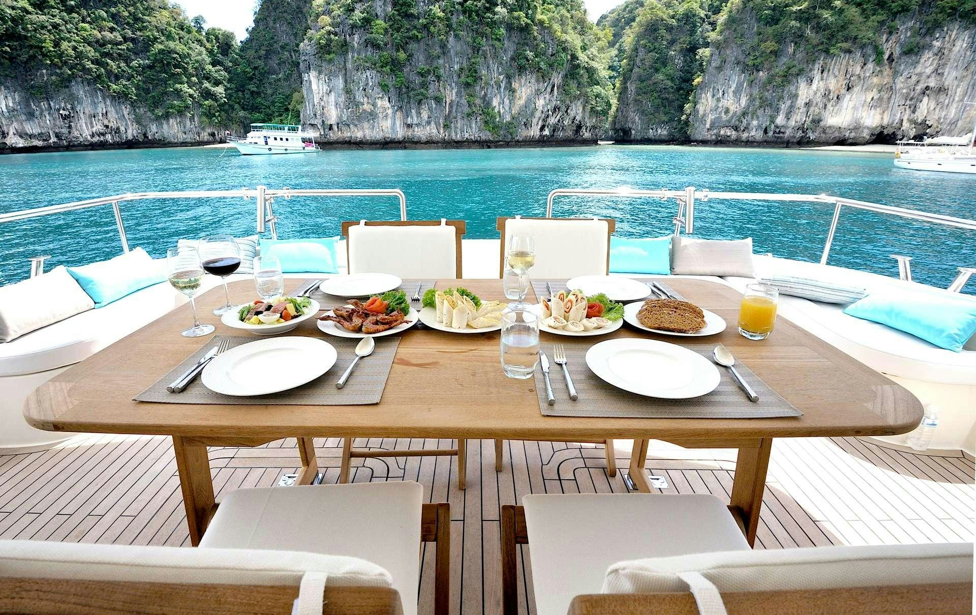 a table set for a meal on a boat aboard LADY KATHRYN Yacht for Charter