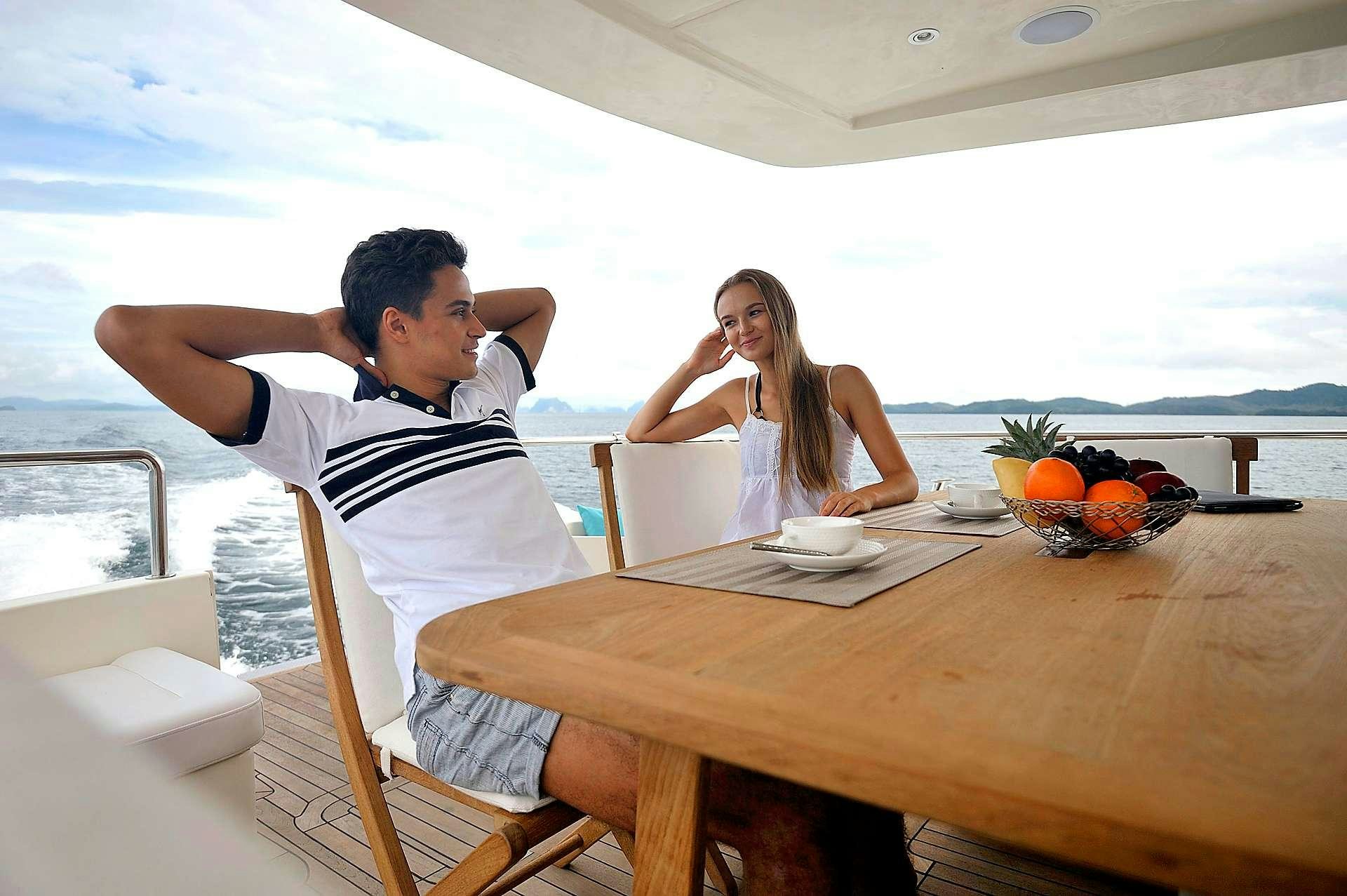a man and a woman sitting at a table aboard LADY KATHRYN Yacht for Charter