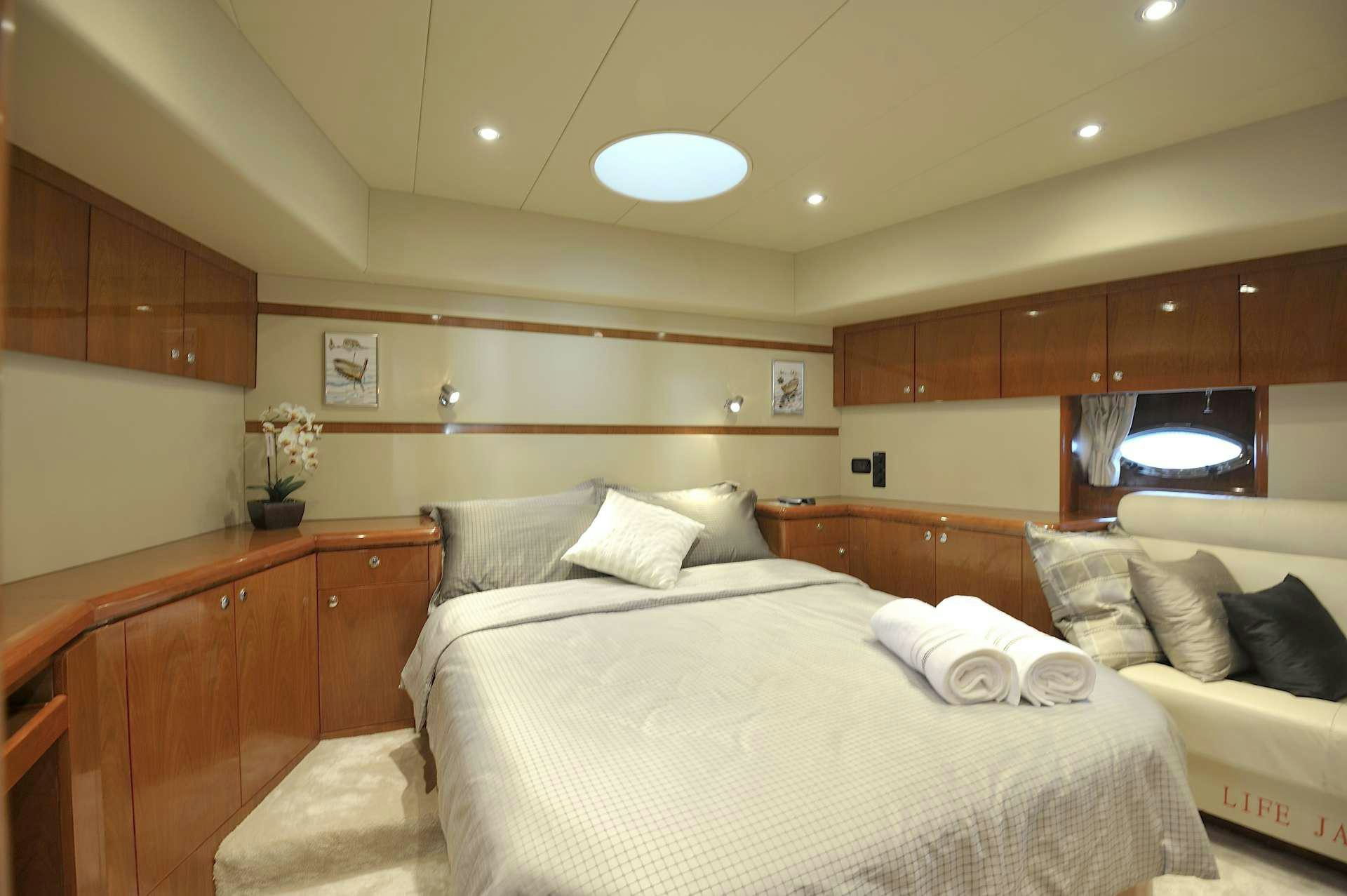 a room with a bed and a television aboard LADY KATHRYN Yacht for Charter