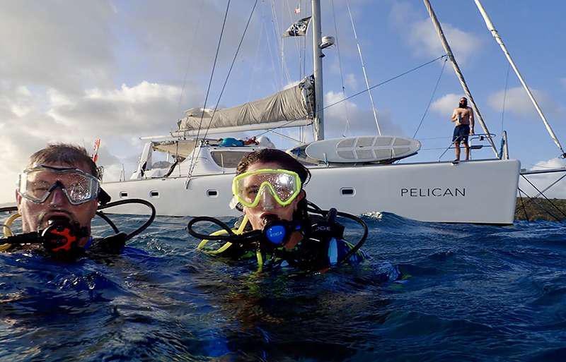 a man and a woman in a boat on the water aboard PELICAN Yacht for Charter