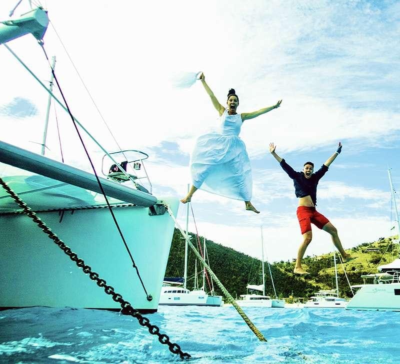 a couple of men jumping into the air from a boat aboard PELICAN Yacht for Charter