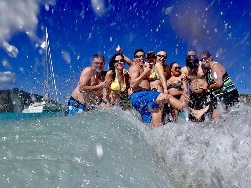 a group of people in the water aboard PELICAN Yacht for Charter