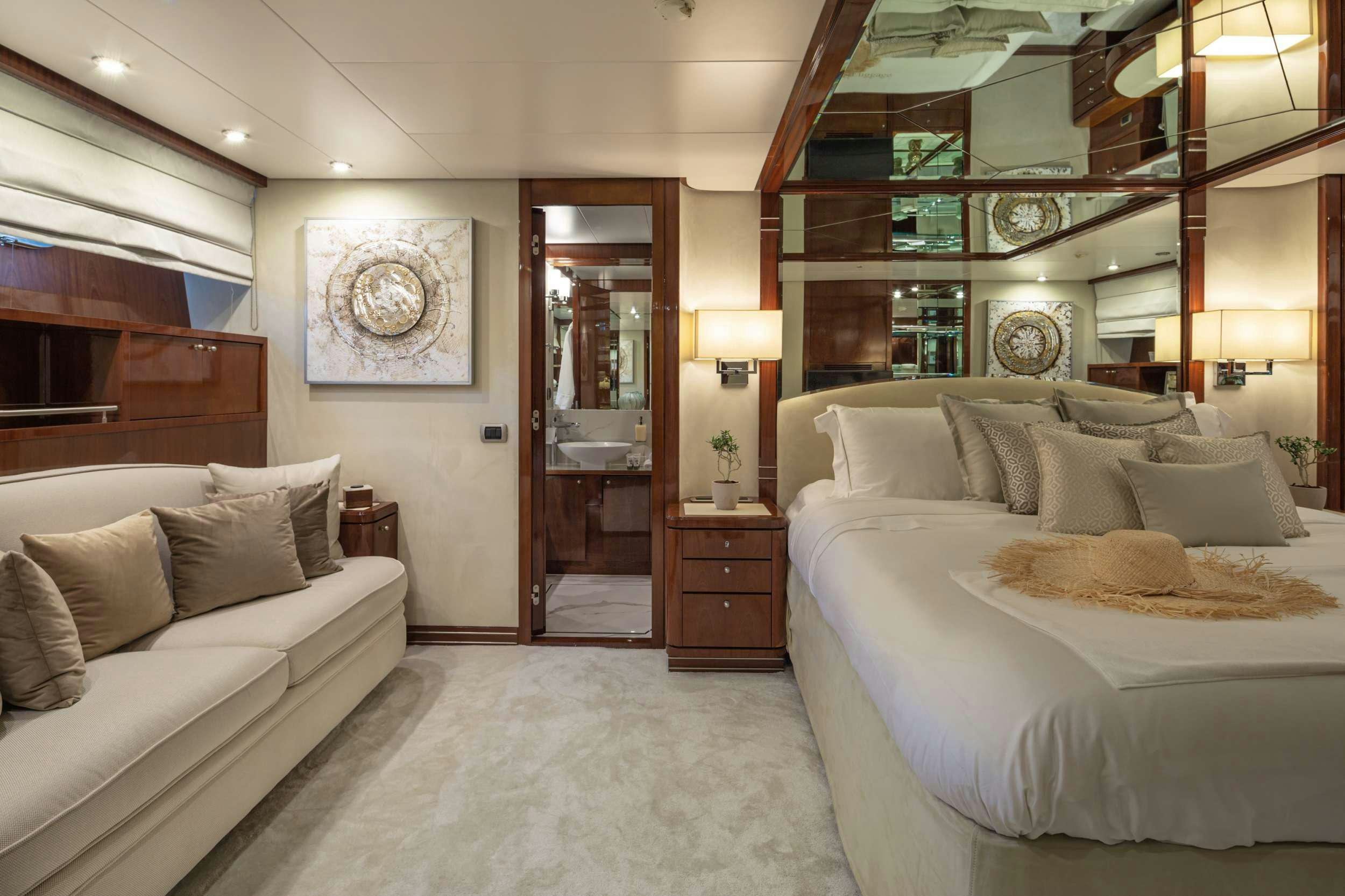a bedroom with a bed and a couch aboard GRACE Yacht for Charter