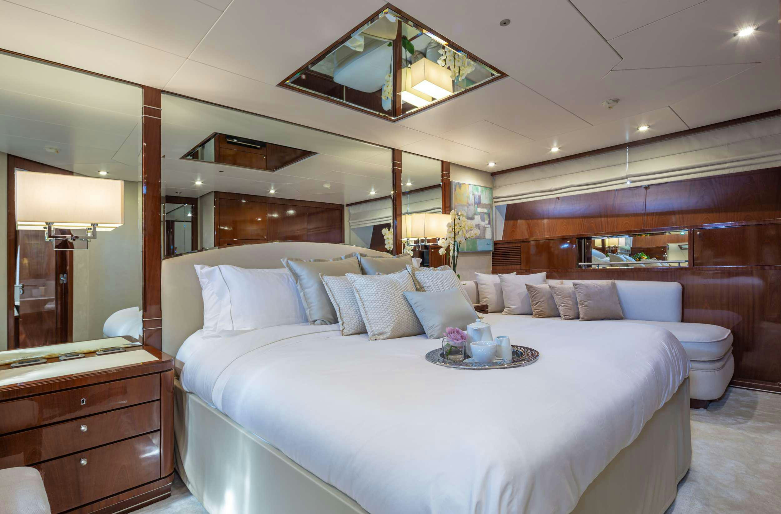 a bed with a white bed spread aboard GRACE Yacht for Charter