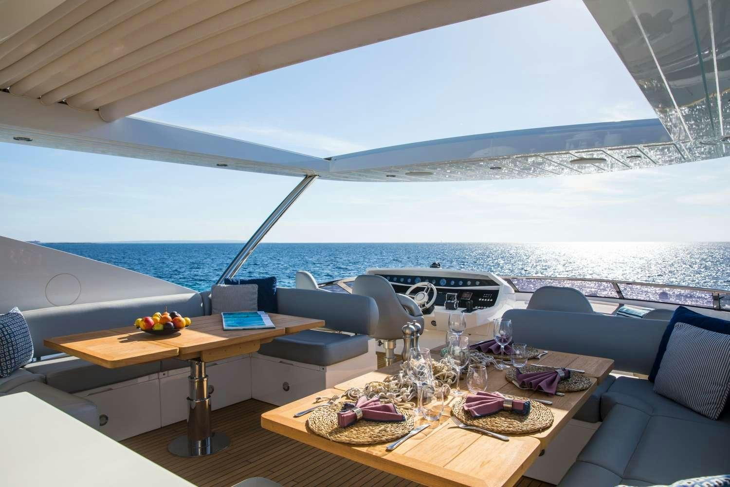 a room with a table and chairs aboard PLAY THE GAME Yacht for Charter