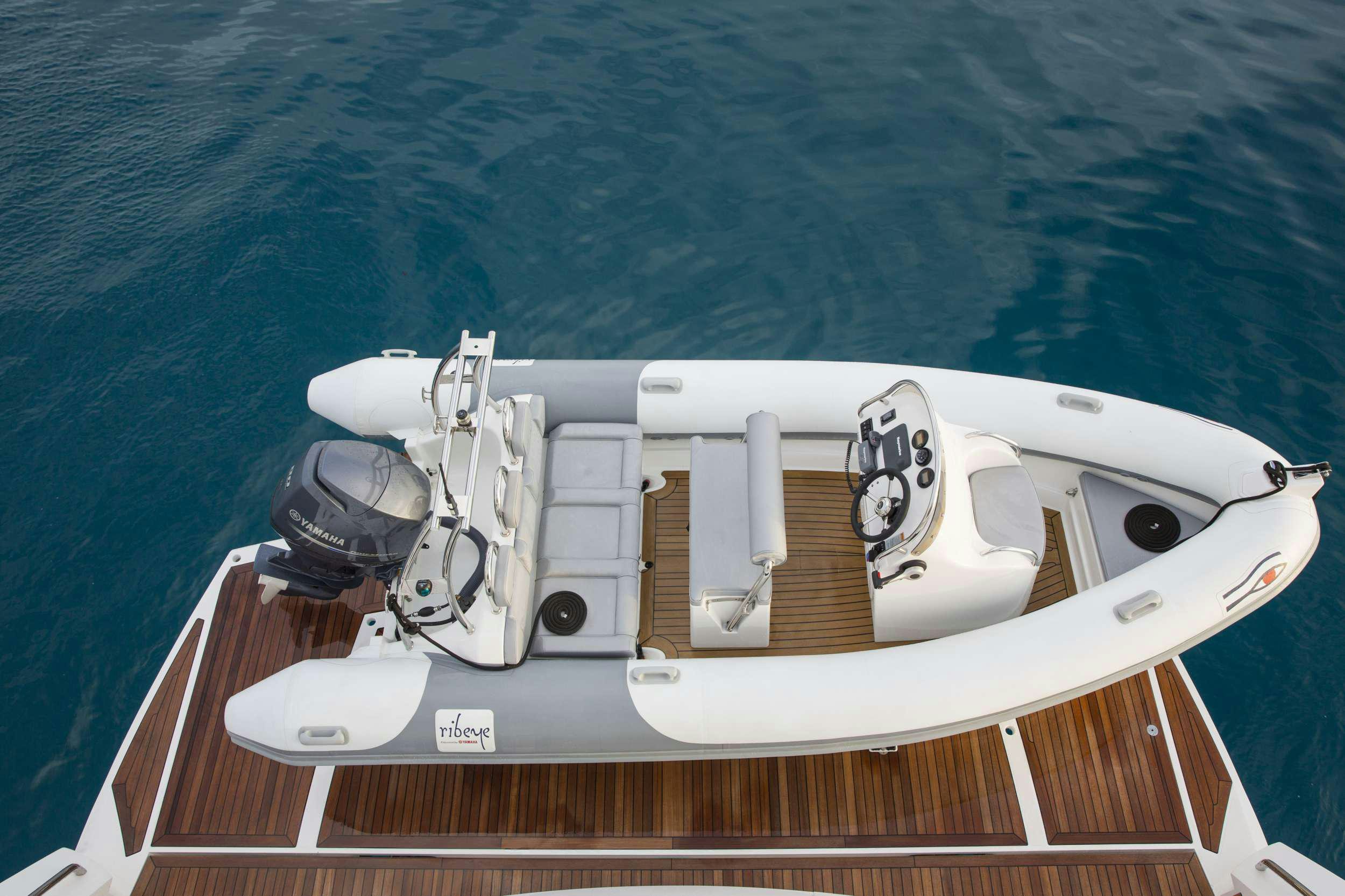 a white boat with a metal frame aboard PLAY THE GAME Yacht for Charter