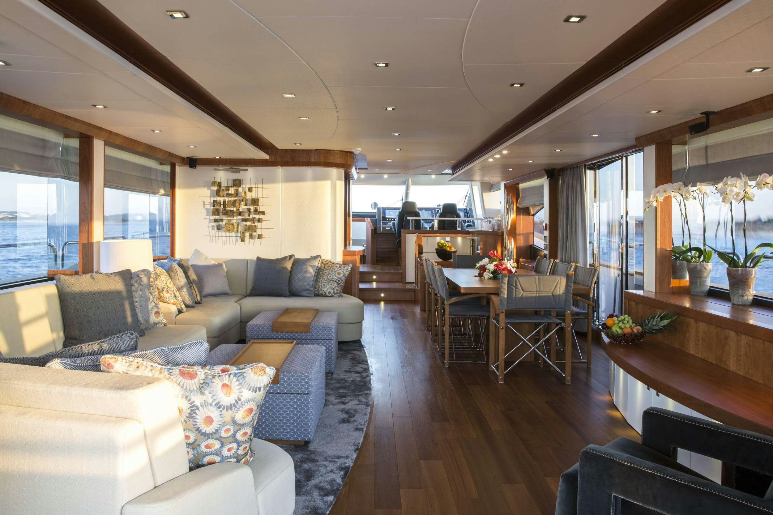 a living room with a couch and a table aboard PLAY THE GAME Yacht for Charter