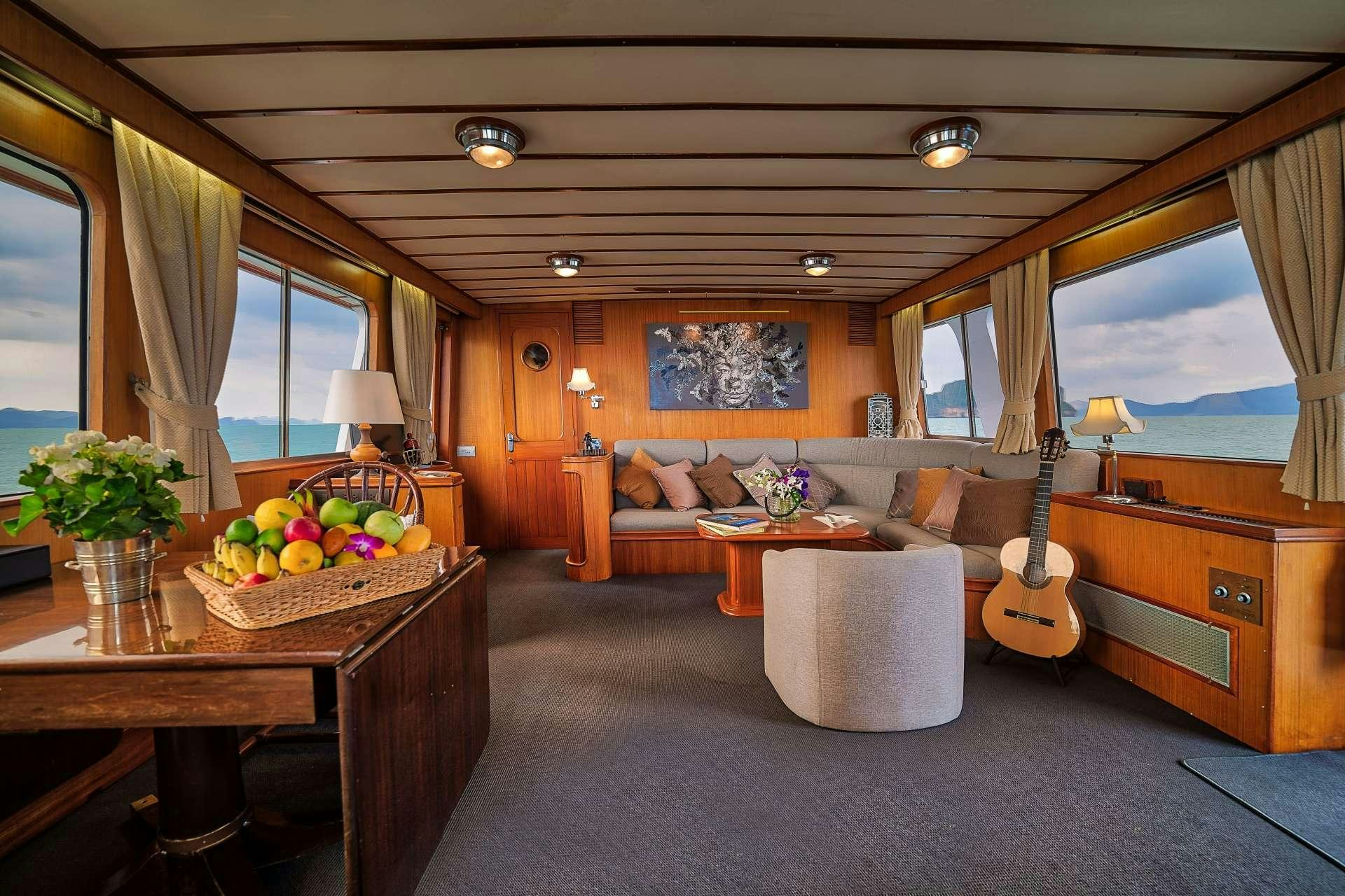 a living room with a guitar and a piano aboard L'ORIENTALE Yacht for Charter