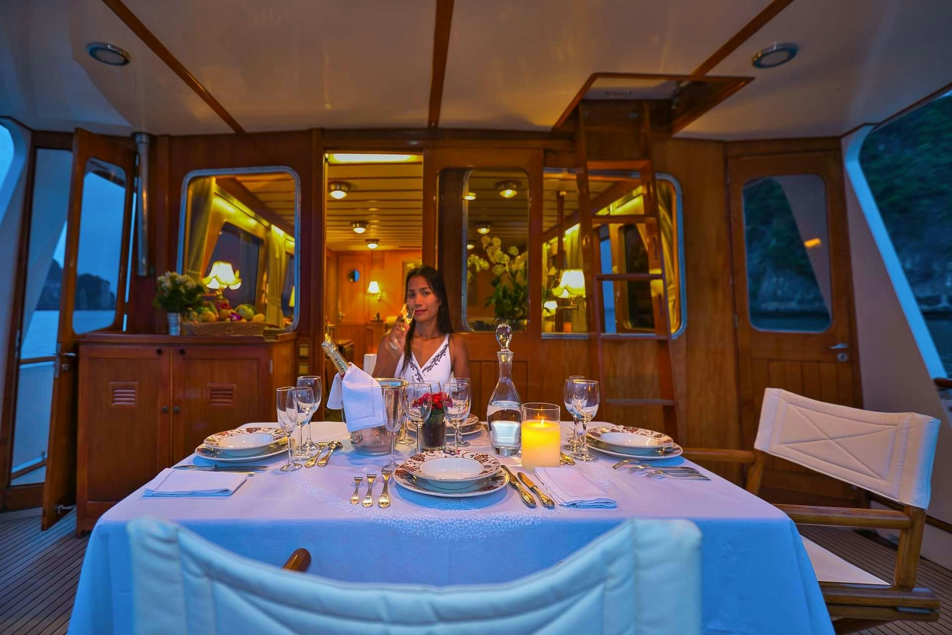a person sitting at a table aboard L'ORIENTALE Yacht for Charter