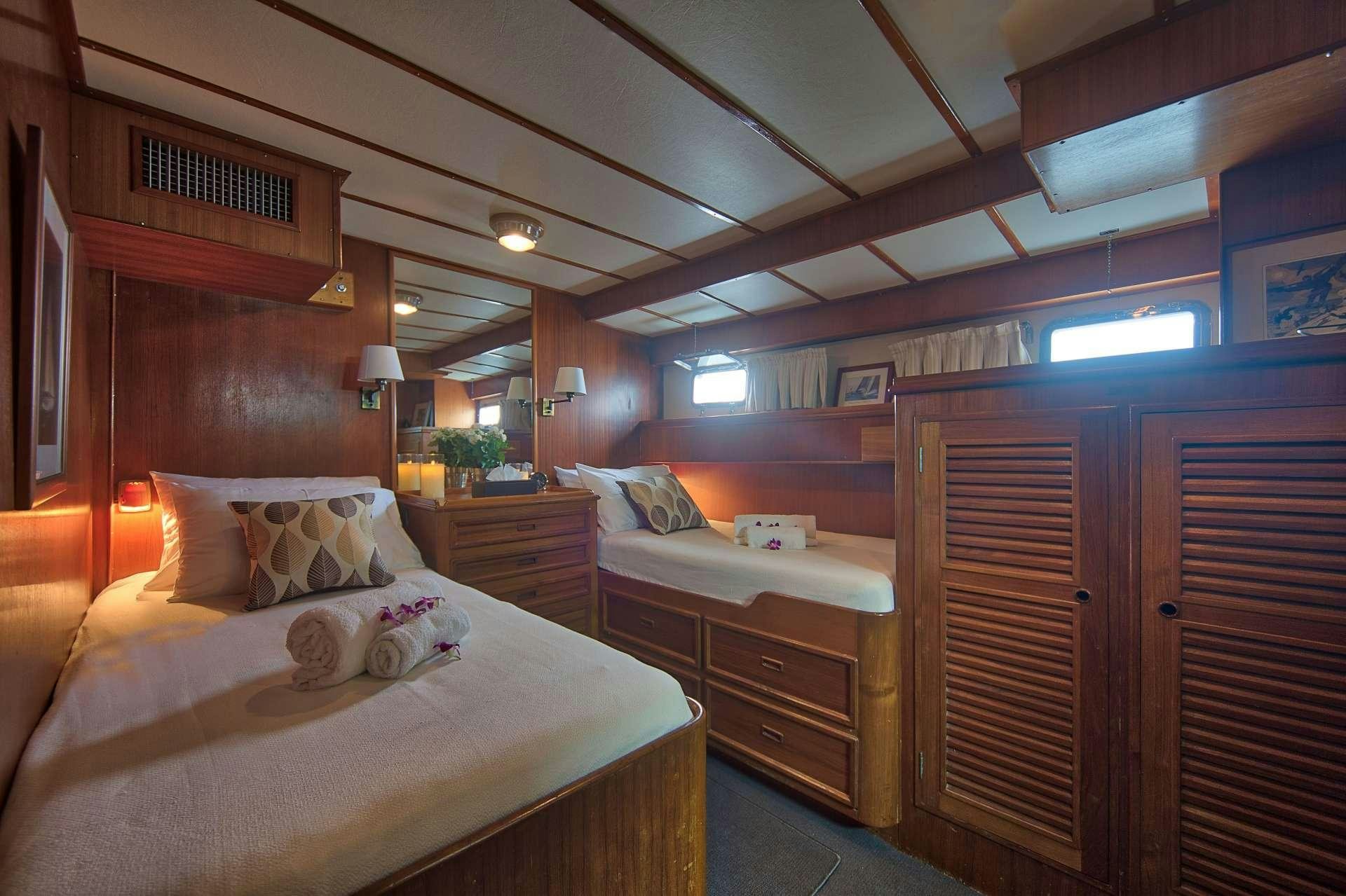 a room with a couple beds aboard L'ORIENTALE Yacht for Charter