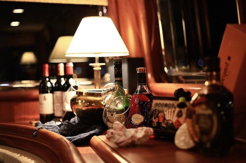 a table with bottles and glasses aboard NURTEN A Yacht for Charter
