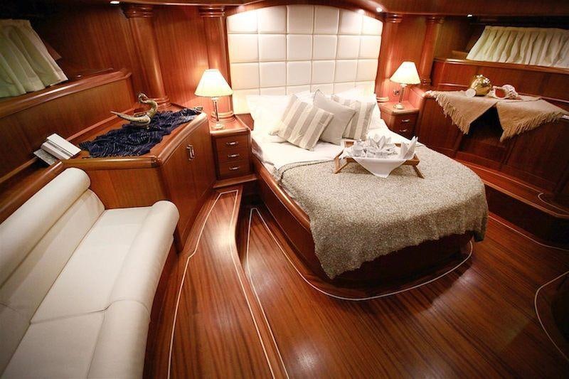 a room with a bed and a table aboard NURTEN A Yacht for Charter