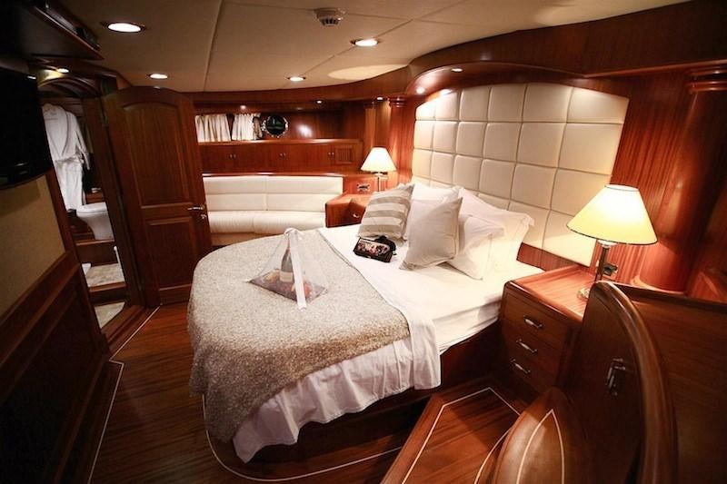 a hotel room with a bed and a lamp aboard NURTEN A Yacht for Charter