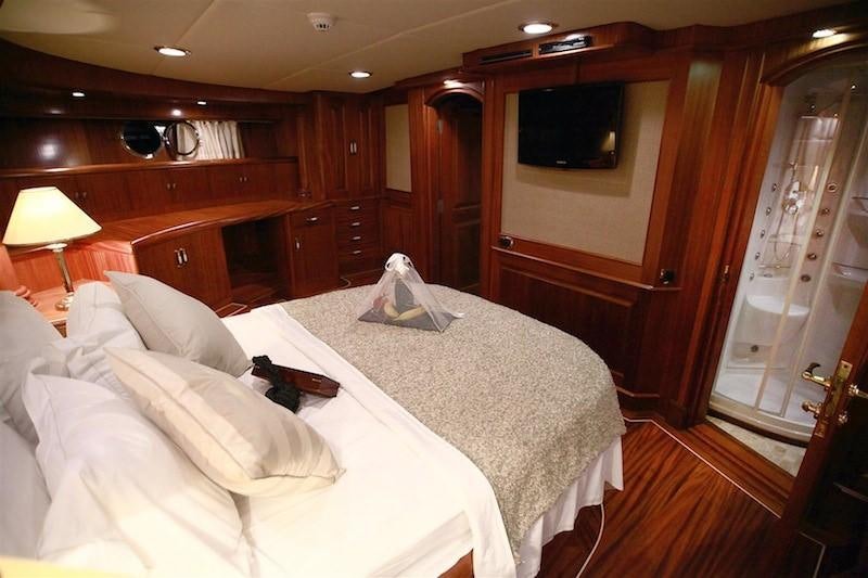 a bedroom with a bed and a television aboard NURTEN A Yacht for Charter