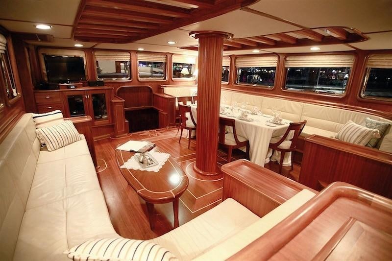 a room with a table chairs and a couch aboard NURTEN A Yacht for Charter