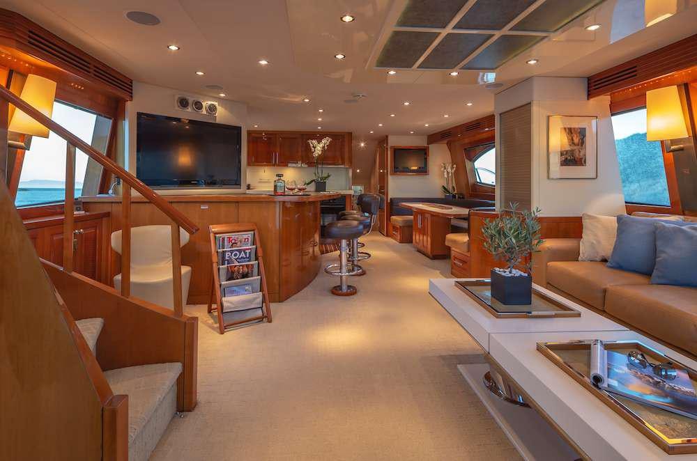a living room with a staircase and a glass coffee table aboard ASTRAPE Yacht for Charter