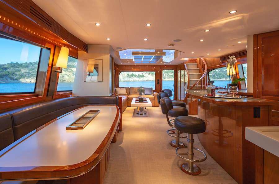 a room with a table chairs and a window aboard ASTRAPE Yacht for Charter
